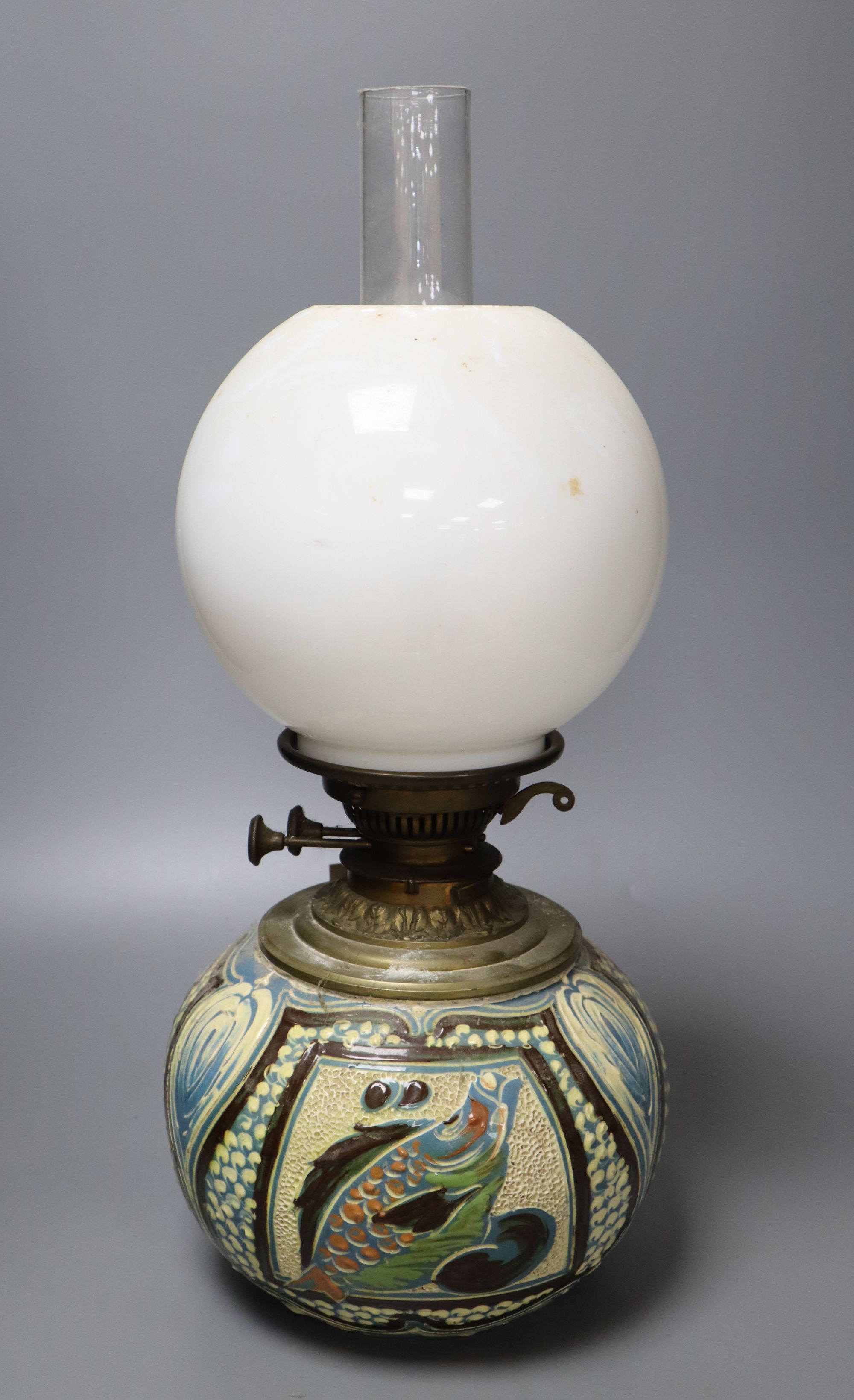 A C. H. Brannam Barum pottery oil lamp, decorated with fish, signed and dated 1899, height 50cm including chimney